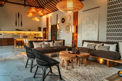 a living room with a couch and a table and chairs at Villa Zarrin Seminyak Bali Luxury 3 bedroom villa in Seminyak