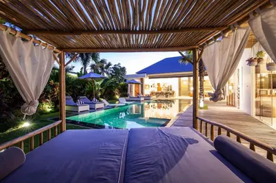 a bedroom in a villa with a swimming pool at Spectacular 4BR Villa, 400m to Beachfront Bliss in Canggu