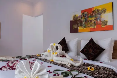 a bed with two carved swans on top of it at Maisaba Seminyak Loft & Villas in Seminyak
