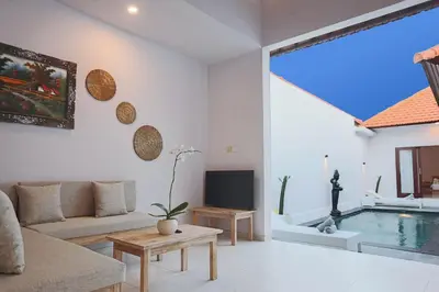 a living room with a couch and a swimming pool at Maisaba Seminyak Loft & Villas in Seminyak