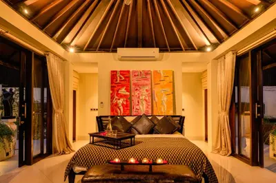 a bedroom with a bed with candles on it at Villa One Seminyak in Seminyak