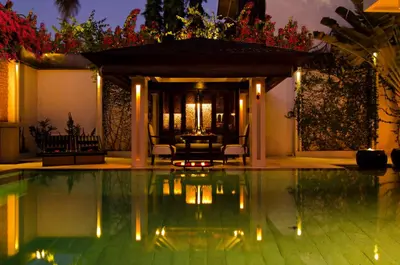 a swimming pool in a villa at night at Villa One Seminyak in Seminyak