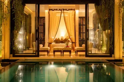 a living room with a pool in front of a house at Villa One Seminyak in Seminyak