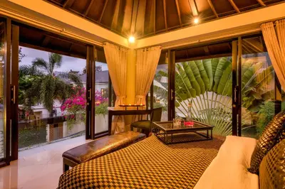 a bedroom with a bed and a large window at Villa One Seminyak in Seminyak