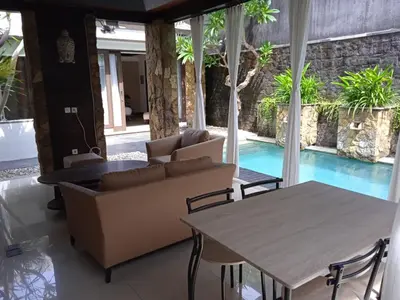 a living room with a couch and a table at Villa Samatha in Nusa Dua