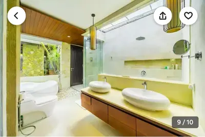 a bathroom with two sinks and a tub and a toilet at Villa Samatha in Nusa Dua