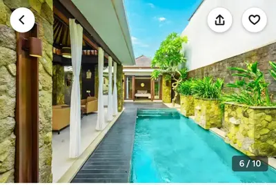 a villa with a swimming pool in front of a building at Villa Samatha in Nusa Dua