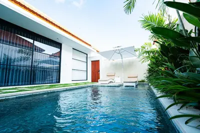 a swimming pool in the backyard of a house at La Boutique Lux's Villas Seminyak Bali in Seminyak