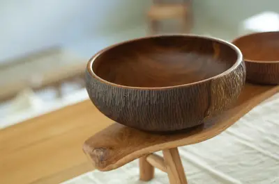a wooden bowl sitting on top of a wooden table at La Boutique Lux's Villas Seminyak Bali in Seminyak