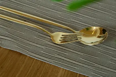 a gold fork and spoon sitting on top of a table at La Boutique Lux's Villas Seminyak Bali in Seminyak