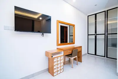 a room with a desk and a mirror at La Boutique Lux's Villas Seminyak Bali in Seminyak