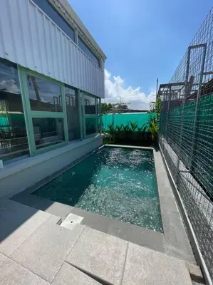 a swimming pool in front of a building at Monty’s Villa Umalas - 1 Bedroom in Kerobokan