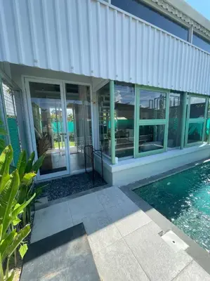 a house with a swimming pool next to a building at Monty’s Villa Umalas - 1 Bedroom in Kerobokan