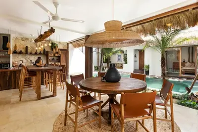 an open kitchen and dining room with a table and chairs at Villa Senya - Bali Bliss 3BR Mediterranean Escape with Private Pool, Stylish Retreat Between Seminyak & Canggu in Kerobokan