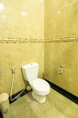 a bathroom with a toilet and a trash can at Villa cinta buana 1 in Legian
