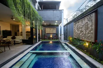 a swimming pool in the middle of a house at Villa cinta buana 1 in Legian