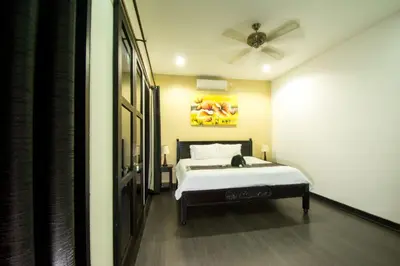 a bedroom with a bed and a ceiling fan at Villa cinta buana 1 in Legian