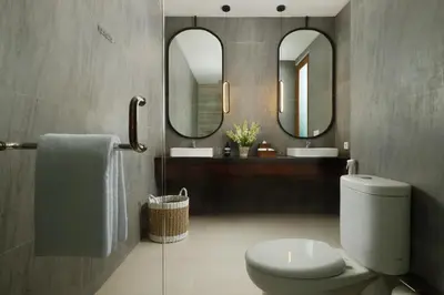 a bathroom with a toilet and two mirrors at Villa Ananya Seminyak by Nakula in Seminyak