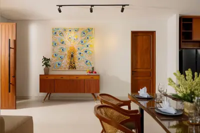 a living room with a table and a painting on the wall at Villa Ananya Seminyak by Nakula in Seminyak