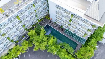 an overhead view of an apartment building with a swimming pool at Kuta Galleria Hotel in Kuta