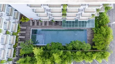 an overhead view of an apartment building with a swimming pool at Kuta Galleria Hotel in Kuta