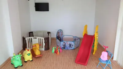 a room with toys and a crib and a slide at Kuta Galleria Hotel in Kuta