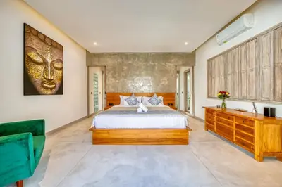 a bedroom with a king sized bed and a dresser at Beautiful villa Yang Tao in the heart of Seminyak with private staff in Seminyak