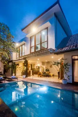 a house with a swimming pool in front of it at Villa Miamara by Bali Villa Solutions in Seminyak