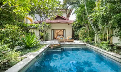 a swimming pool in front of a villa at Villa Seriska Seminyak, 5-Star Private Pool Villa, Walk to Dining & Shopping in Seminyak