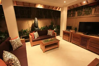 a living room with a couch and a flat screen tv at Villa Seriska Seminyak, 5-Star Private Pool Villa, Walk to Dining & Shopping in Seminyak