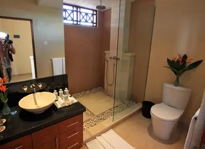 a bathroom with a shower and a sink and a toilet at Villa Seriska Seminyak, 5-Star Private Pool Villa, Walk to Dining & Shopping in Seminyak