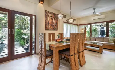 a dining room with a table and a couch at Villa Seriska Seminyak, 5-Star Private Pool Villa, Walk to Dining & Shopping in Seminyak