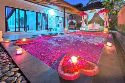 a large pool covered in pink flowers in a house at Romantic Private Villas Kuta Bali in Kuta