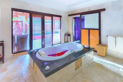 a large bathroom with a large bath tub at Romantic Private Villas Kuta Bali in Kuta