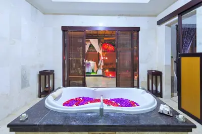 a bathroom with a bath tub filled with flowers at Romantic Private Villas Kuta Bali in Kuta