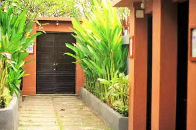 a house with a black door and some plants at Romantic Private Villas Kuta Bali in Kuta