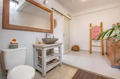 a bathroom with a sink and a toilet at Villa Anouk in Seminyak