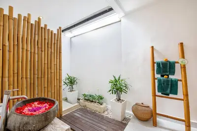 a room with a bath tub and potted plants at Villa Anouk in Seminyak