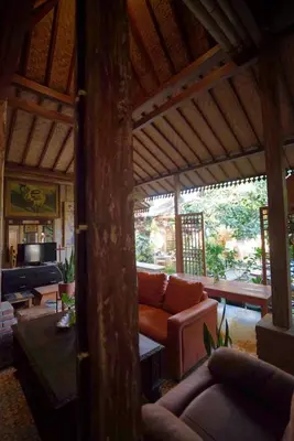 a living room with a couch in a pavilion at Oma Joglo Jimbaran in Jimbaran
