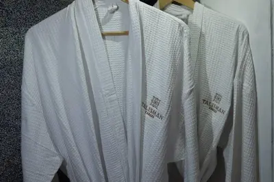 a group of white shirts hanging on a rack at Villa Talisman - Luxury Rooftop Canggu Villa Only 5 mins to Beach in Canggu