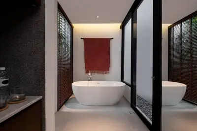 a bathroom with a large tub and two sinks at Villa Talisman - Luxury Rooftop Canggu Villa Only 5 mins to Beach in Canggu