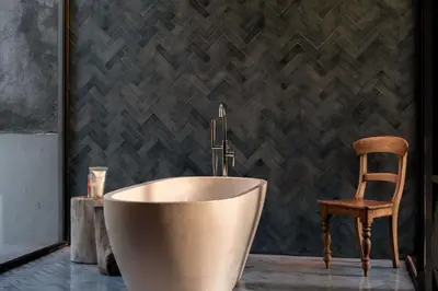 a bathroom with a bath tub and a chair at Casa Madi Canggu in Canggu