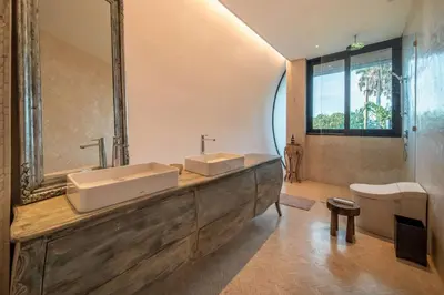 a bathroom with two sinks and a large mirror at Casa Madi Canggu in Canggu