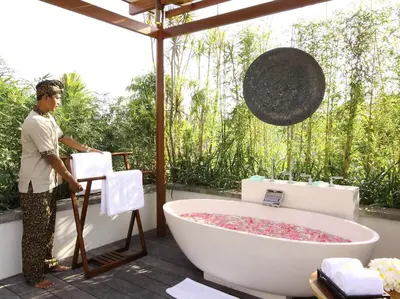 a man standing in a bathroom with a bath tub at Dea Villas in Canggu