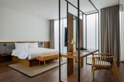 a hotel room with a bed and a desk and a chair at Villa Talisman - Stylish Canggu with Rooftop Villa 5 mins to Beach in Canggu