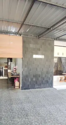 a room with a stone wall in a building at Laura Dewi House in Jimbaran