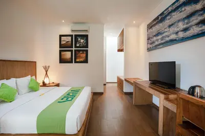 a bedroom with a large bed and a flat screen tv at Sedasa Lodge in Canggu
