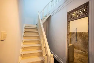 a staircase in a building with a wooden door at Villa Dolcevita Seminyak in Seminyak