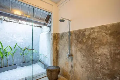 a bathroom with a shower with a glass door at Villa Dolcevita Seminyak in Seminyak