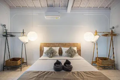 a bedroom with two pairs of shoes on a bed at Villa Dolcevita Seminyak in Seminyak
